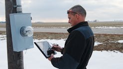 Norris Public Power District lineman collects data in field.