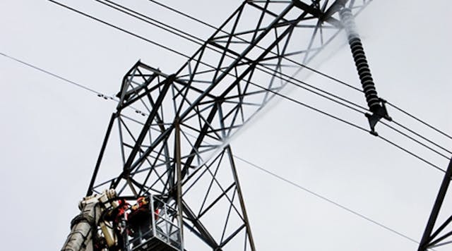 Technicians wash insulators from the platform of a Bronto aerial on live 500-kV lines.