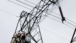 Technicians wash insulators from the platform of a Bronto aerial on live 500kV lines Technicians wash insulators from the platform of a Bronto aerial on live 500kV lines