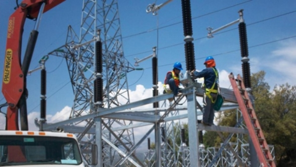 Operators constructing a power transmission line