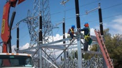 Operators constructing a power transmission line.