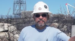 Patrick Flores is shown on the site of restoration in Warner Springs, California. Lightning caused a fire in San Diego County, and Flores and his crew were assigned to rebuild lines and restore power to a rural community.