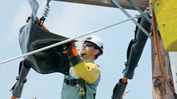The lineman Shaun Geiman of Harrisburg Pennsylvania is covering up the energized line in preparation for the installation of a new smart switch The lineman Shaun Geiman of Harrisburg Pennsylvania is covering up the energized line in preparation for the installation of a new smart switch