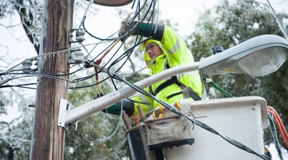 A Santee Cooper lineman works on lines after an ice storm