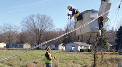 Consumers Energy linemen work together to restore power.