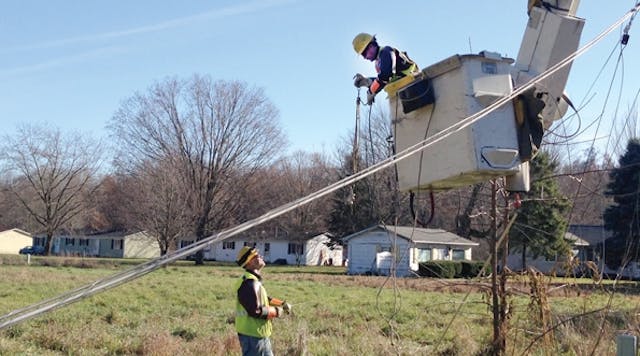 Consumers Energy linemen work together to restore power.