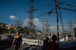 Transmission towers and power lines with people in the foreground Transmission towers and power lines with people in the foreground