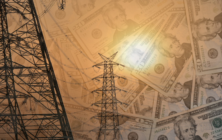 Composite representational image showing transmission towers in the foreground and dollar notes in the background