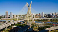 A cityscape with a bridge in the foreground