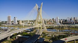 A cityscape with a bridge in the foreground A cityscape with a bridge in the foreground