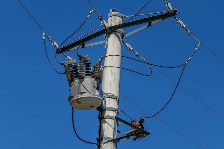 An overhead electricity pole and power lines