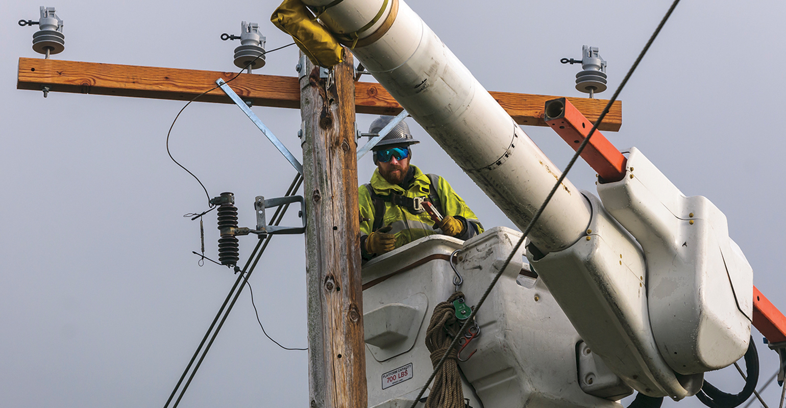 A lineman works out of a bucket truck to get the lights back on for PSE&rsquo;s customers