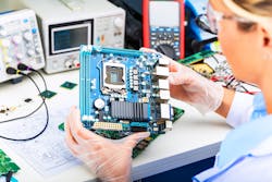 A person holds an electronic motherboard A person holds an electronic motherboard