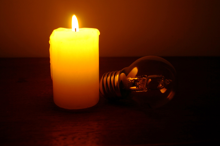 A lit candle and an unlit bulb