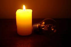 A lit candle and an unlit bulb A lit candle and an unlit bulb