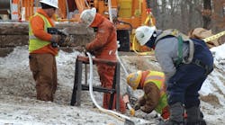 Linemen prepare the conductor ends for the imploding connector. Linemen prepare the conductor ends for the imploding connector.