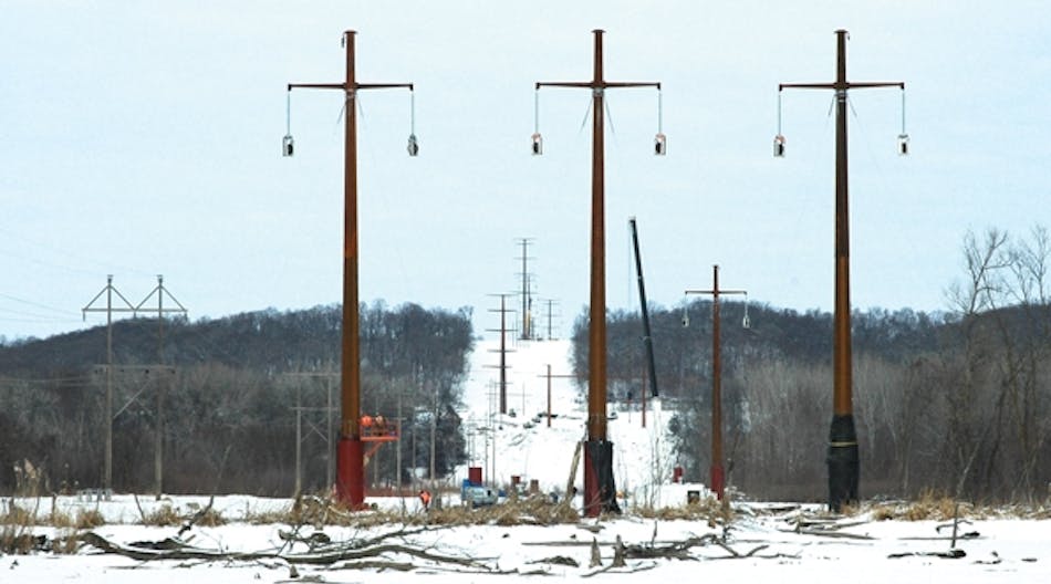 A view facing north through the Minnesota River crossing area shows the transition from three monopole structures with horizontal conductor configuration to a vertical quad circuit configuration in the background, where the utility colocated with the adjacent lines.