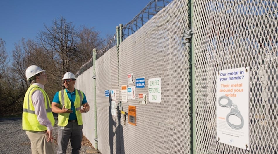 Matt Green (left), director of engineering, and Javier Morales, substation engineering senior engineer, discuss the heightened security measures at one of PPL Electric Utilities substations.