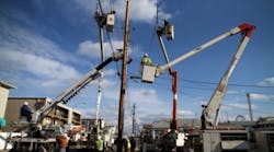Utility workers replace a pole that was damaged by Superstorm Sandy on November 25, 2012 in Seaside Heights, New Jersey. New Jersey Gov. Christie estimated that Superstorm Sandy cost New Jersey $29.4 billion in damage and economic losses. (Photo by Mark Wilson/Getty Images)