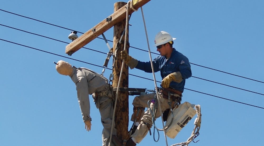 A journeyman performs a pole-top rescue during a bundled training session.