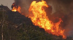 Jan. 16, 2014, a large wildfire burns out of control in the hills above Glendora, California. Firefighters, helicopters and aircraft from many jurisdictions work to control it. Courtesy of Digital Media Pro/Shutterstock.com.