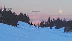 Moonrise over the Chugach Mountains illuminates some of the new structures installed during the Quartz Creek transmission line rebuild.