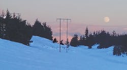 Moonrise over the Chugach Mountains illuminates some of the new structures installed during the Quartz Creek transmission line rebuild.