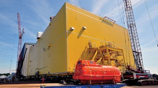 The HelWin2 platform at the Heerema Shipyard in Zwijndrecht, Netherlands, is loaded onto the barge for transport to the wind farm cluster.