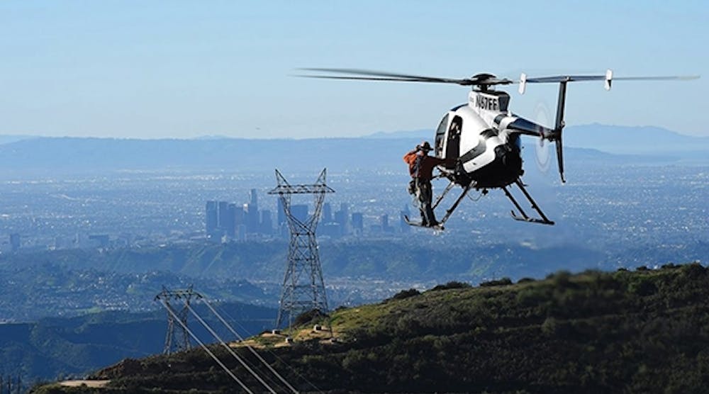 Wayne Temple is shown in route to a structure with a lineman using the skid transfer method. The project will provide renewable energy to the people of Los Angeles, California.