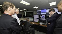 DOE representatives look into the brain of the intelligent grid at CenterPoint Energy&apos;s technology center.