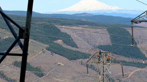 A BPA line maintenance crew makes an urgent repair with helicopter support in a rugged setting near Mount Hood