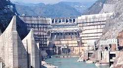 The front view of the double-curvature arch dam with seven surface outlets, eight mid-level orifices and four spillway tunnels. The front view of the double-curvature arch dam with seven surface outlets, eight mid-level orifices and four spillway tunnels.