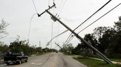 Power lines bend in the wake of Hurricane Wilma on Oct. 24, 2005, in Ft Lauderdale, Florida. Hurricane Wilma hit the Western coast of Florida as a Category Three and departed the eastern coast as a Category Two hurricane. High winds from the fast moving hurricane caused widespread power outages across the state. (Photo by Richard Patterson/Getty Images)
