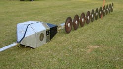 A closeup of the aerial saw on the ground with rotary blades and box housing the motor A closeup of the aerial saw on the ground with rotary blades and box housing the motor
