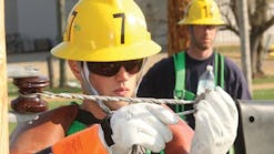At the Marshall Training Center, an apprentice uses proper cover up and personal protective equipment while practicing a de-energized secondary connection from the ground.