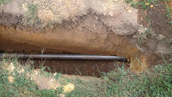 The boring pipe is visible beneath the ground in this section that was first excavated to remove rock