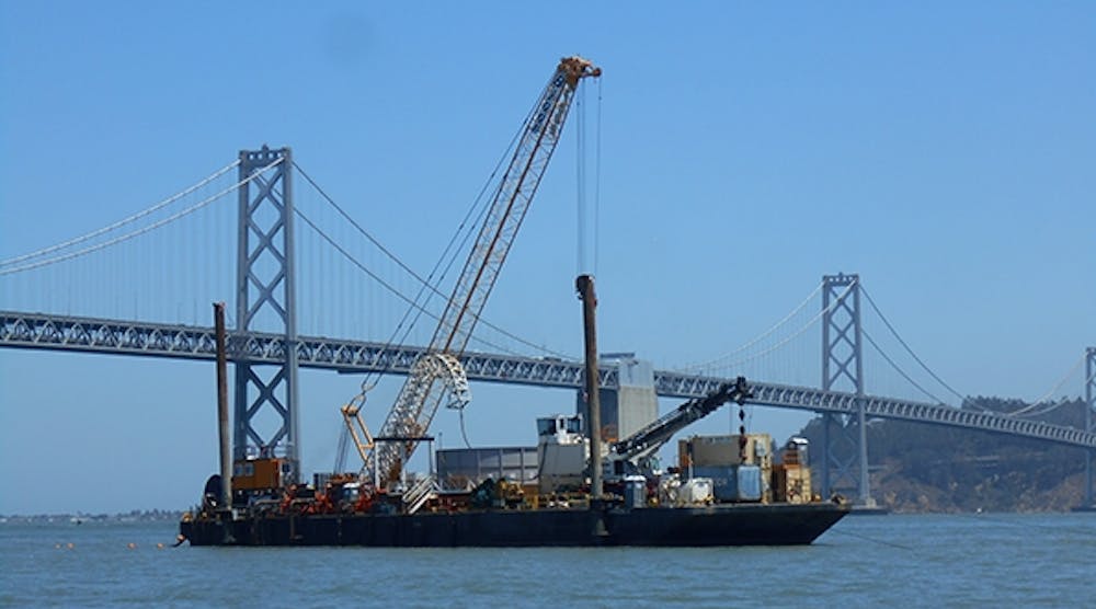 A barge carrying submarine 230-kV cable for a PG&amp;E transmission and substation upgrade project sails under the Bay Bridge between San Francisco and Oakland.
