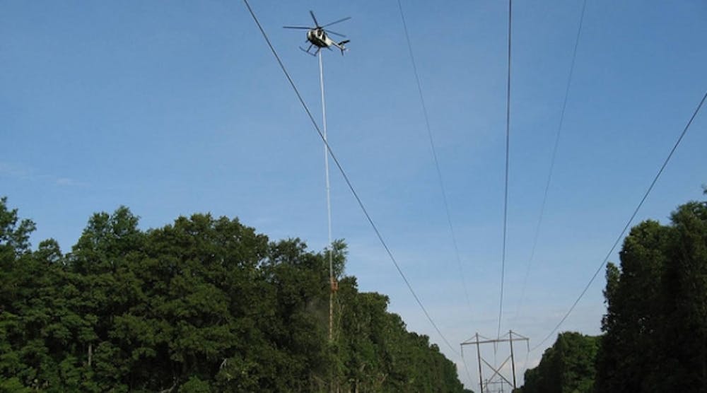 The aerial saw trims a transmission right-of-way, able to reach all tree limbs no matter how high from the ground.