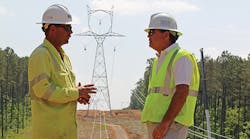 Georgia Transmission Corp.&rsquo;s Tim Jones (right) meets with the construction crew that will be pulling and securing conductor on the towers for the Heard County 500-kV transmission line project.
