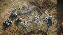 Crews lace lattice tower sections on the ground. The new galvanized steel structures replaced Cor-Ten structures built in the 1960s.