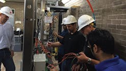 On deployment day, the team &mdash; from the left, Evandro Oliveira, Siemens application engineer; Mike Ramlachan, ALSTOM lead application engineer; Eric Stranz, Siemens business development manager; Mark Mills, Siemens networking engineer; and ShreyasPawale, Entergy settings engineer &mdash; configures the parallel redundancy protocol network for all the IEDs.