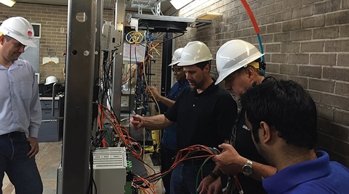 On deployment day, the team &mdash; from the left, Evandro Oliveira, Siemens application engineer; Mike Ramlachan, ALSTOM lead application engineer; Eric Stranz, Siemens business development manager; Mark Mills, Siemens networking engineer; and ShreyasPawale, Entergy settings engineer &mdash; configures the parallel redundancy protocol network for all the IEDs.