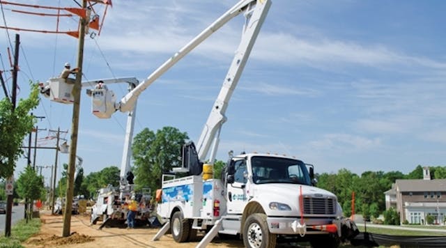 A Duke Energy line crew uses bucket trucks with boom lifts to perform work in Charlotte, North Carolina.
