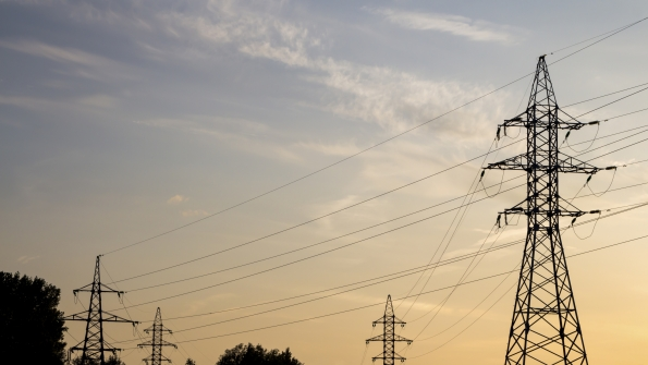 Four transmission towers during a sunset