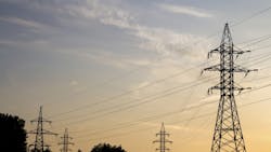 Four transmission towers during a sunset Four transmission towers during a sunset