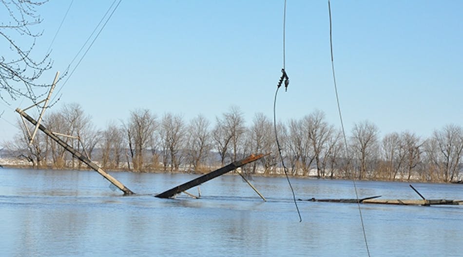 Two 12.5-kV lines rest in the Illinois River after a towboat pushing 12 barges hit a bridge in Florence, Illinois. One of the runaway barges destroyed an H-frame structure on the flooded banks of the river, and a small outage occurred interrupting service to 55 residential customers for approximately 4.5 hours.