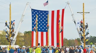 Veteran OUC linemen climbed three separate poles to hang local and state flags before the competition began.