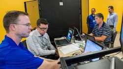 From left to right NREL39s Brian Miller works with David Cronin of DC Systems Duane Petersen then with Scitor Corporation Brandon Hjella of FireEye and NRELrsquos Erfan Ibrahim to build the Test Bed for Secure Distributed Grid Management a hardware system that mimics the communications power systems and cybersecurity layers for a utility39s power distribution system From left to right NREL39s Brian Miller works with David Cronin of DC Systems Duane Petersen then with Scitor Corporation Brandon Hjella of FireEye and NRELrsquos Erfan Ibrahim to build the Test Bed for Secure Distributed Grid Management a hardware system that mimics the communications power systems and cybersecurity layers for a utility39s power distribution system