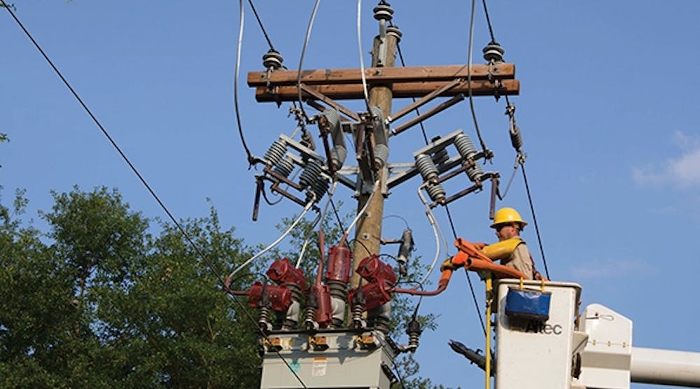 Lineman Brad Selman inspects and repairs a recloser installation typical of the CGEMC system.