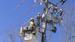 A PPL Electric Utilities line worker installs a smart grid switch in their Pennsylvania service territory. The company recently implemented the technology, which enables automated power restoration in minutes.